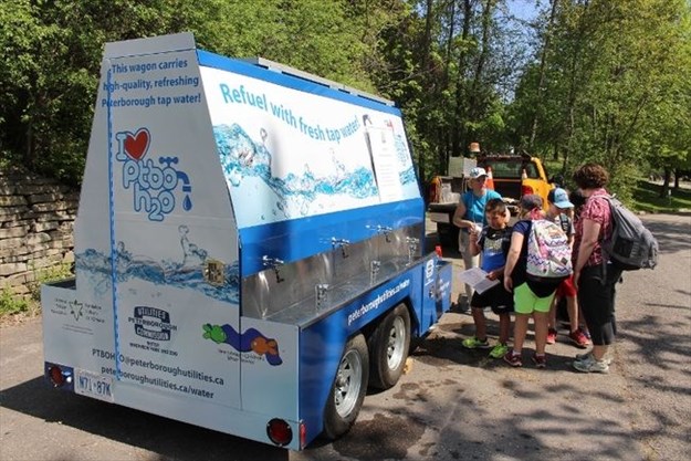  tap water station and kids in the park