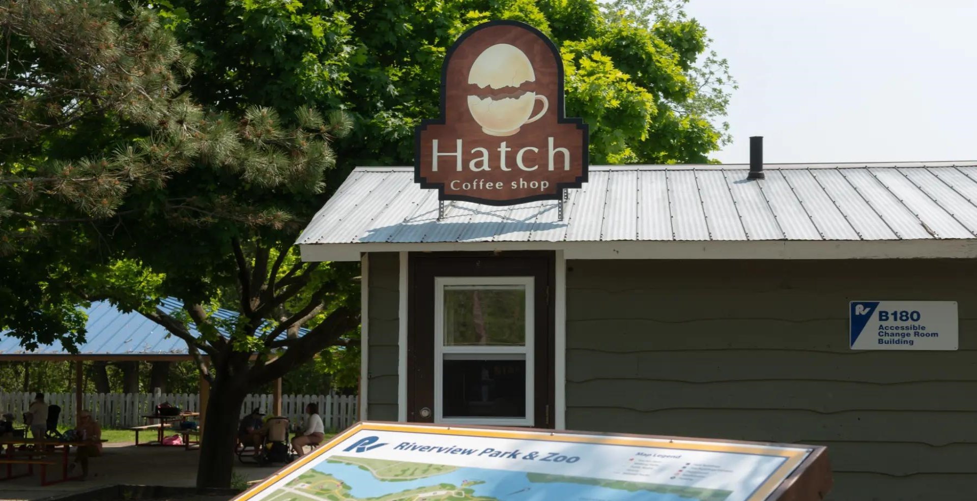 building with Hatch cafe sign in front of playground area