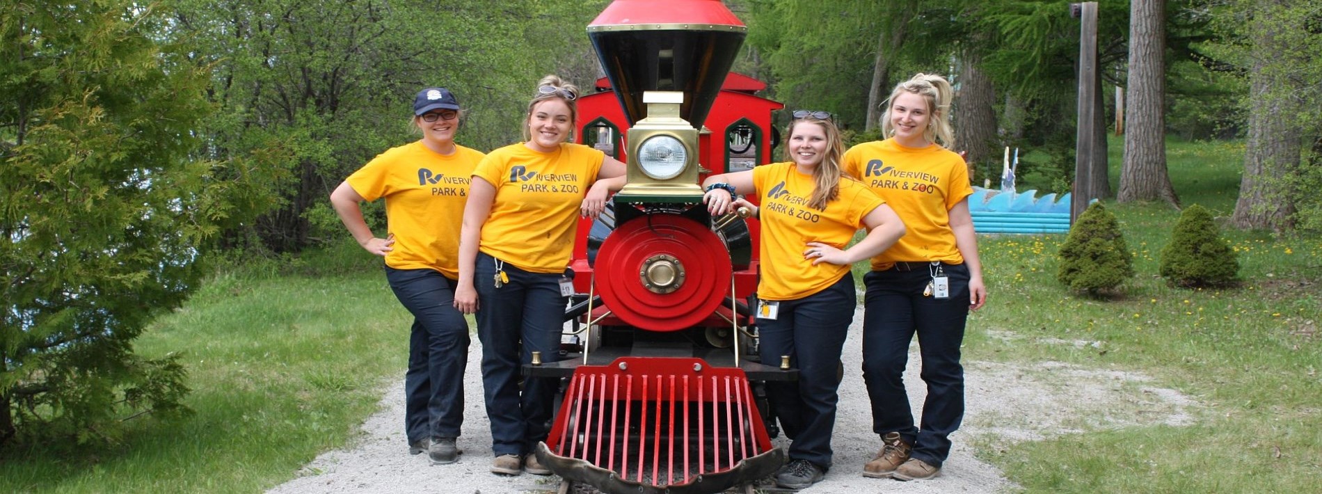 zoo students standing around the miniature train