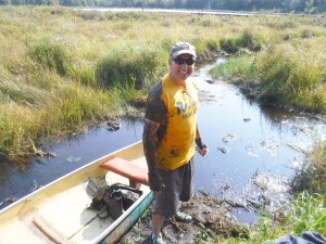 staff in small boat for wildlife release into creek