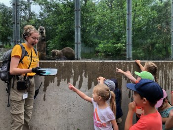 group of children outside of the otter exhibit