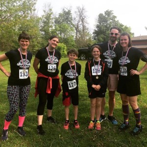 fun run competitors with numbers and metals