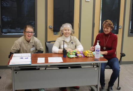 three volunteers at registration desk