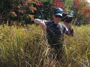 research in the field with detection equipment surrounded by long grass