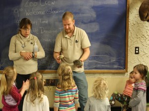 Two educator with turtles in front of classroom of young students