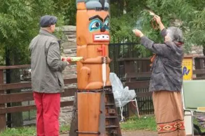 First Nations people rededicating the totem pole