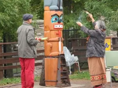 First Nations people rededicating the totem pole
