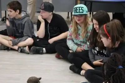 children watching turtles cross the floor