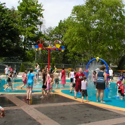a splash pad water sprinklers and children playing  