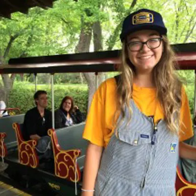 train conductor student standing in front of the train