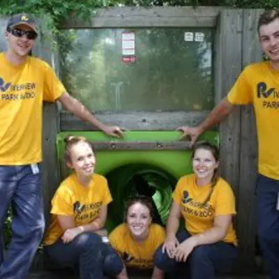 staff members at the top of the green super slide