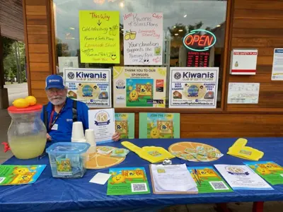 Man sitting behind a table selling lemonade